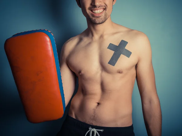 Athletic young man with martial arts pads — Stock Photo, Image