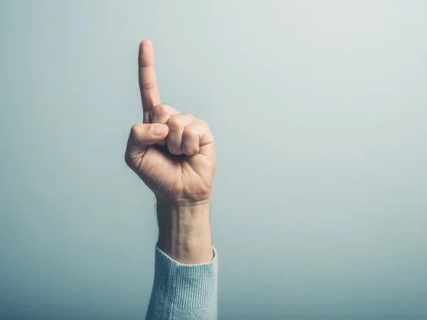 Male hand with finger pointing up — Stock Photo, Image