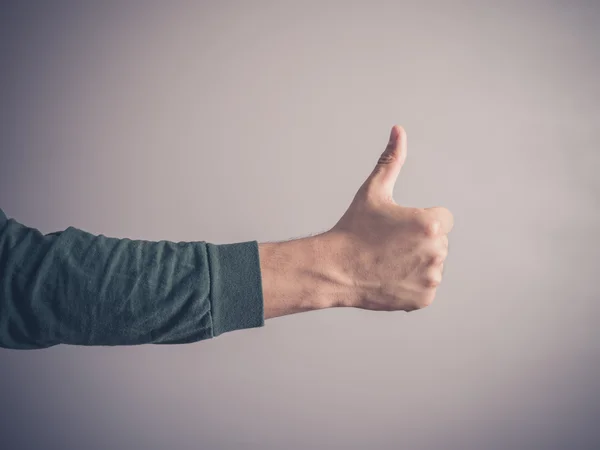 Young man giving thumbs up — Stock Photo, Image