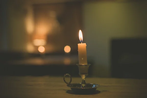 Candle on table in dining room — Stock Photo, Image