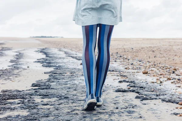 Legs of young woman on beach — Stock Photo, Image