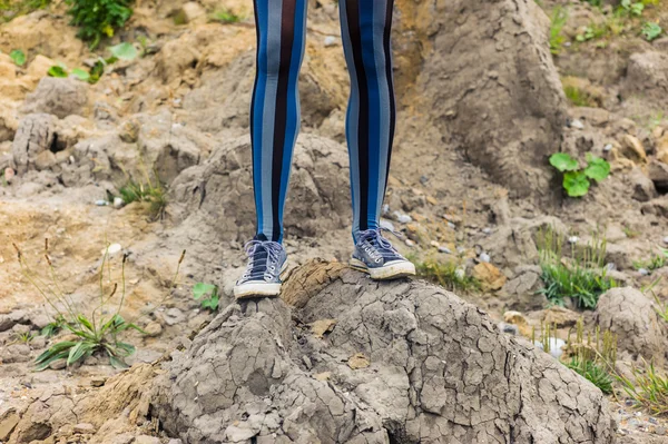 Jambes de femme debout sur un monticule de terre — Photo