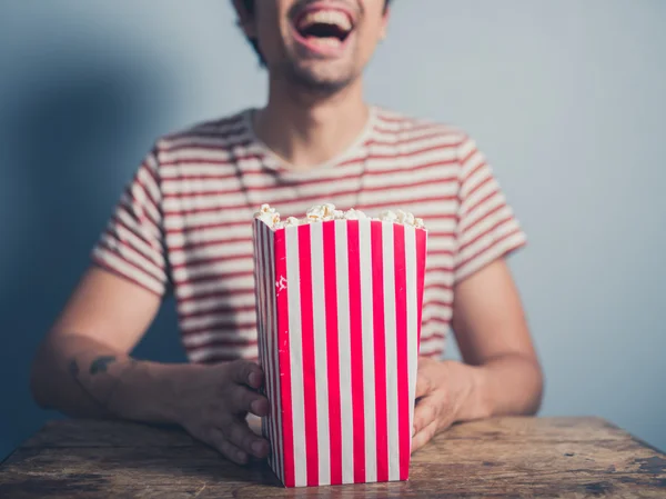 Gelukkig jonge man met popcorn — Stockfoto