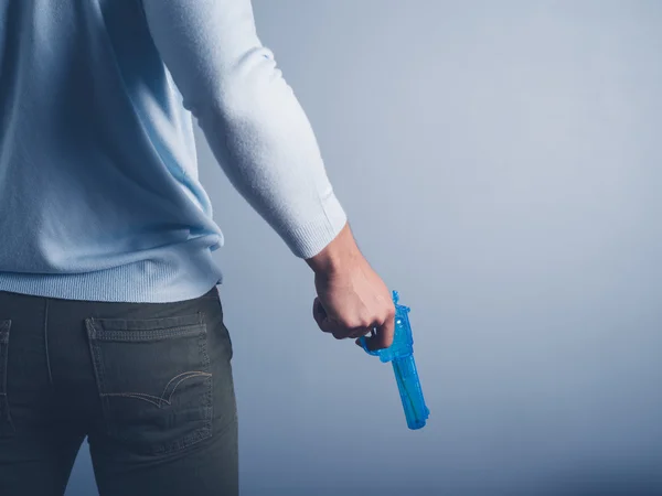 Jovem posando com pistola de água — Fotografia de Stock