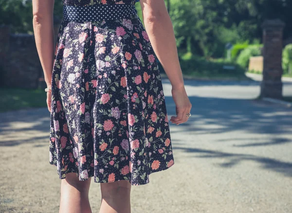 Woman in dress standing outside — Stock Photo, Image