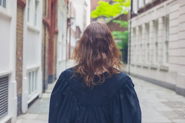 Young woman in graduation gown — Stock Photo, Image