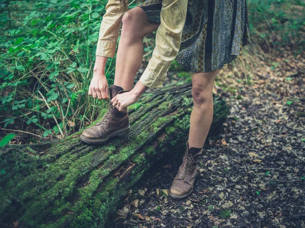 Frau schnürt ihre Schuhe im Wald — Stockfoto