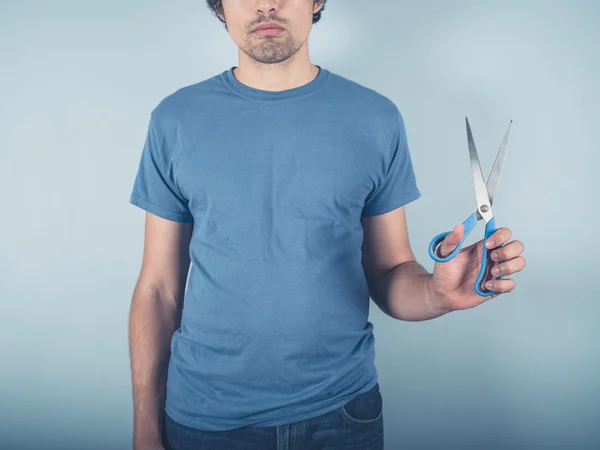 Young man with scissors — Stock Photo, Image