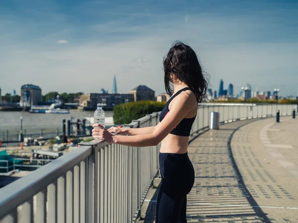 Fit jeune femme avec bouteille d'eau en ville — Photo