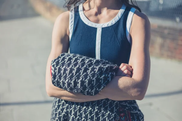 Young woman in dress holding jumper — Stock Photo, Image