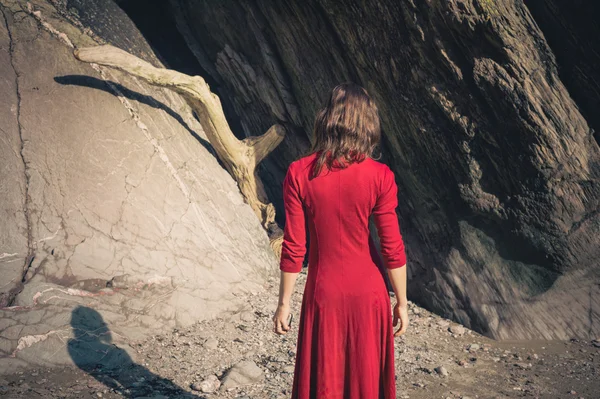 Ung kvinna från cave på stranden — Stockfoto