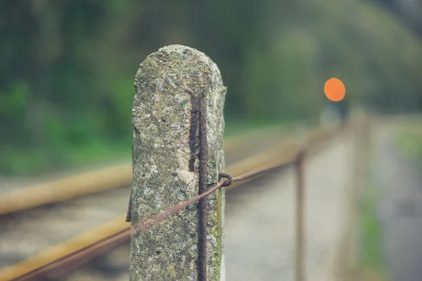 Concrete post by railway track — Stock Photo, Image