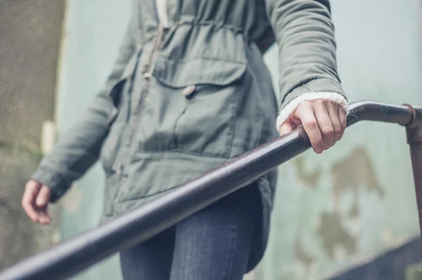 Woman touching banister outside — Stock Photo, Image