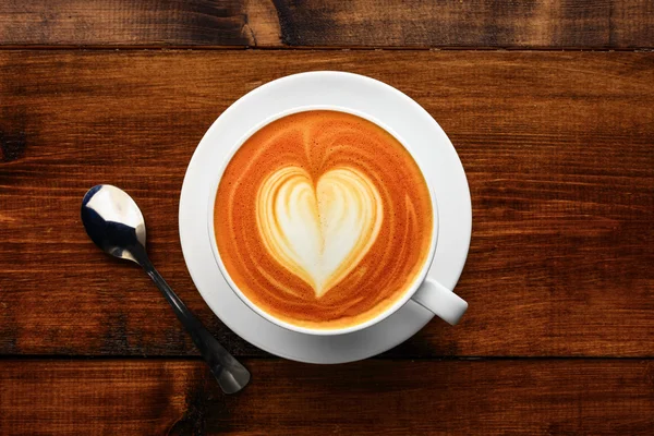 Cup of cappuccino on a wooden table — Stock Photo, Image