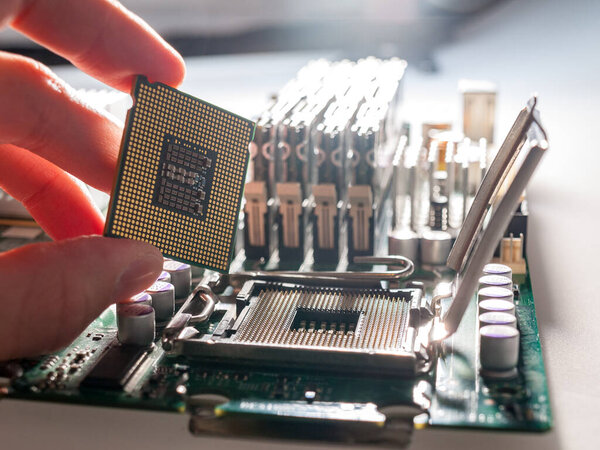 the process of connecting the CPU to the processor socket on a modern computer motherboard, replacing the silicon data processing chip, and correctly installing the central processing unit