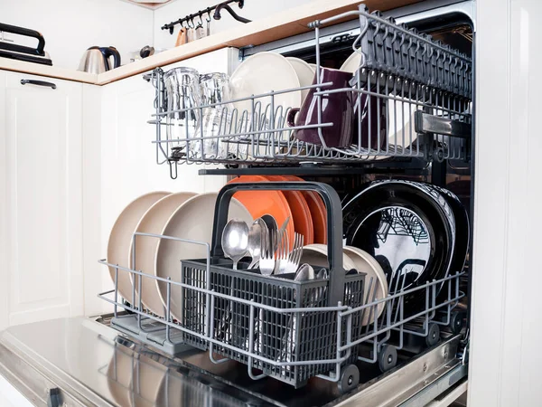 dishwasher close-up with washed dishes, easy to use and save water, eco-friendly, built-in kitchen dish washing machine