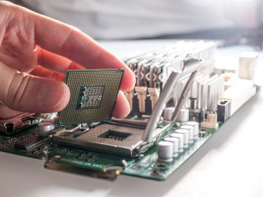 CPU 'yu modern bir bilgisayar anakartındaki işlemci soketine bağlama, silikon veri işleme çipinin yerini alma ve merkezi işlem birimini doğru bir şekilde kurma süreci