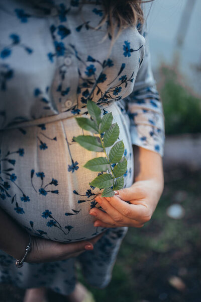 pregnant woman with a leaf in her hands