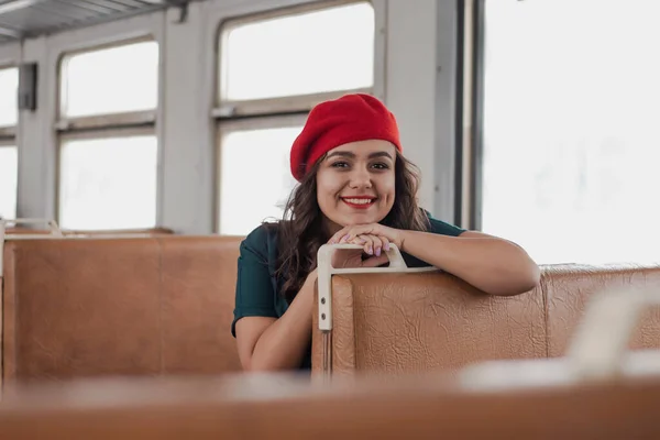 girl in vintage clothes with a suitcase rides in a train