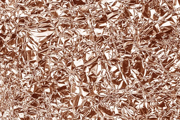 Glanzend folie patroon voor de achtergrond en schaduw. Kreukt. Rose goud — Stockfoto