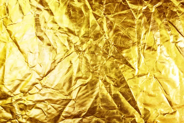 Fondo dorado o textura y sombra. Pliegue de tela de oro —  Fotos de Stock