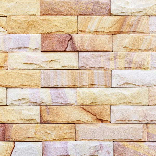 Zand stenen muur achtergrond van decorate — Stockfoto