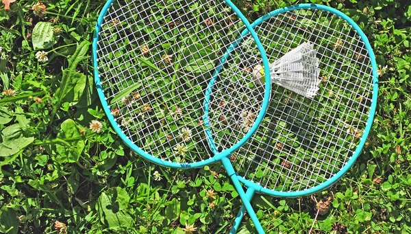 Badminton rackets in the grass — Stock Photo, Image