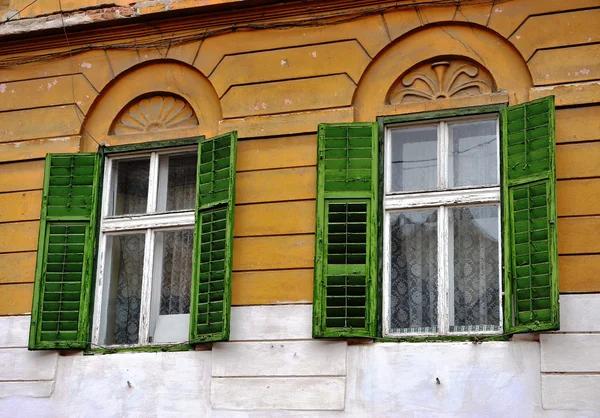 Offene Holzfenster mit den grünen Jalousien — Stockfoto