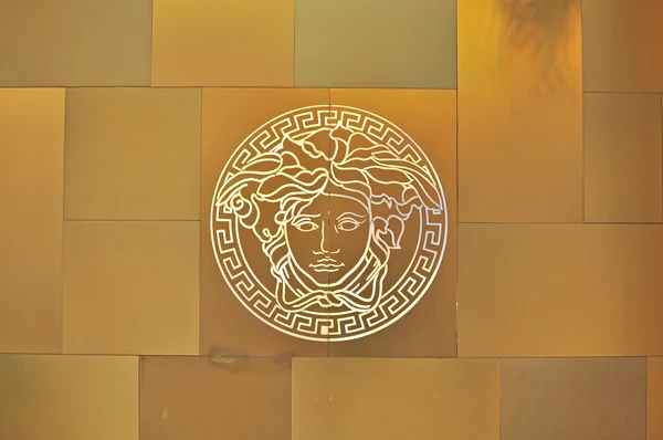 Versace logo on golden background — Zdjęcie stockowe