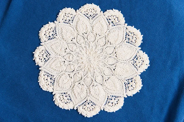 white napkin handmade embroidery on a blue background. Cozy arrangement of the house made of ecological materials