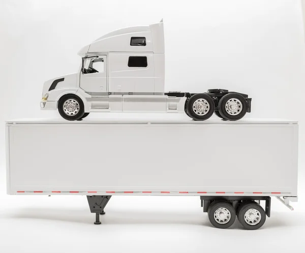 View of transport truck and trailer model vehicles on white, grey background — Stock Photo, Image