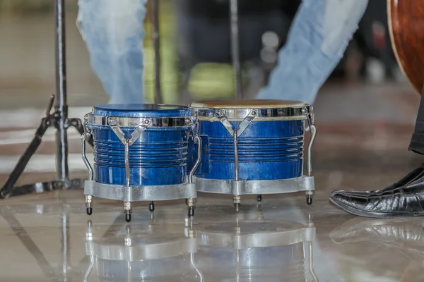 Wspaniały widok na błękitne bongosy drewniane stojąc na błyszczący marmurową podłogą, otoczony przez ludzi nogi — Zdjęcie stockowe