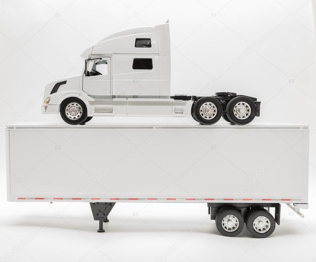 View of transport truck and trailer model vehicles on white, grey background