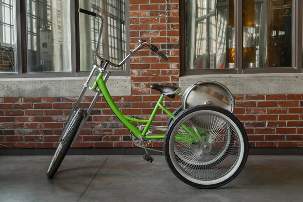 View of tricycle classic bike with aluminum beer barrel on the back, parked against old brick wall — Stock Photo, Image