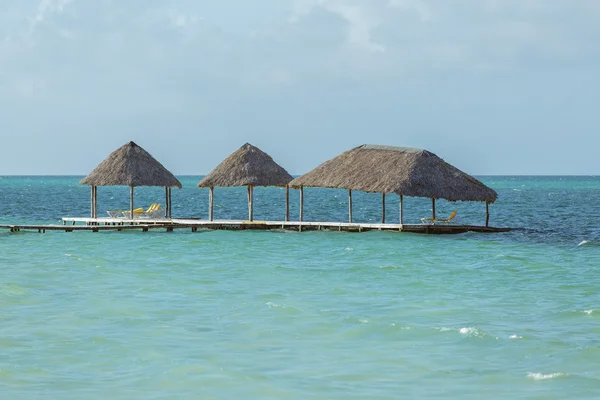 Old wooden pier looks like floating in the ocean high tide — Stock Photo, Image