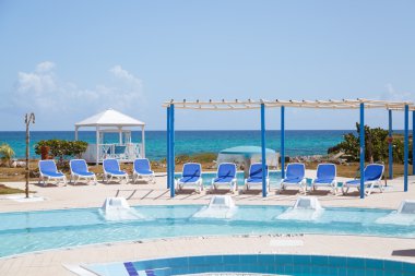 inviting amazing gorgeous view of outdoor spa swimming pool and grounds against tranquil ocean background