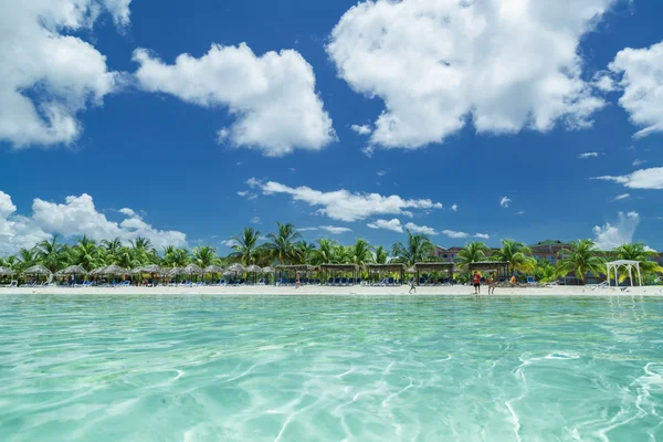 Amazing inviting view of Cuban, Cayo Coco beach from the tranquil turquoise ocean side, with people in background — Stockfoto