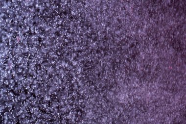 Seçici odaklı soyut şenlik arkaplanı. Koyu arkaplanda parlak beyaz parçacıklar. Sıçramalar, uzay enerji akışı