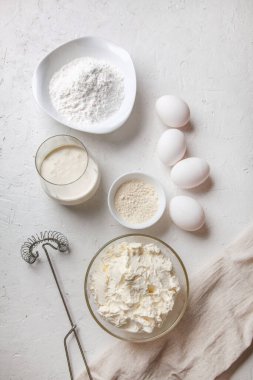 Bask İspanyolcası pişirmek için gereken malzemeler yanmış Aziz Sebastian peynirli keki. Pişirme ürünleri - krem peynir, şeker, yumurta, un ve krema. Tarif adım adım düz düz üst görünüm.