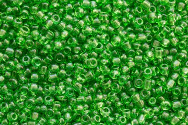 Yeşil renkli boncukların arkaplan dokusu yakın plan. Kusursuz boncuk dokusu. Hobiler, el yapımı mücevherler, zanaat. Soyut arkaplan
