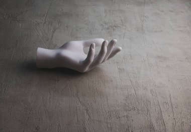 Gri beton yüzeyde plastik el. Minimalizm. Boşluğu kopyala