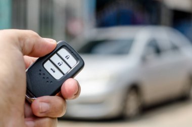 Car smart key is an electronic access and authorization system, Hand holding smart key of car.
