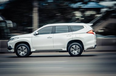 Samut Sakhon, Thailand - August 2019: Motion image, MITSUBISHI Pajero sport white car running on the Rama II Road at Samut Sakhon Province on August,12, 2019 in Samut Sakhon, Thailand.