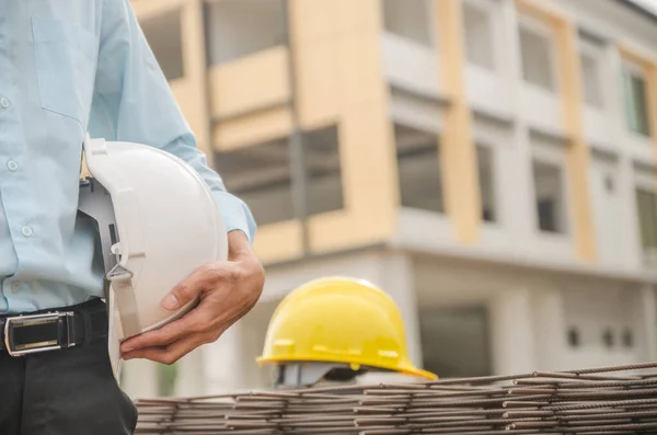 White helmet in the hands of an engineer