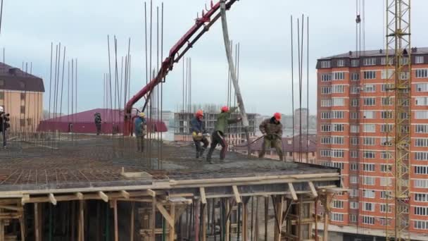 Bauarbeiter gießen flüssigen Beton mit Pumpe auf oberes Stockwerk — Stockvideo