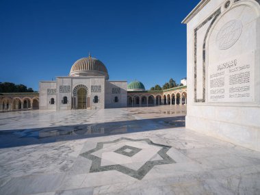 Manastır 'daki büyük Habib Bourguiba mozolesinde güneş ışığında bir yürüyüş. Altın kubbeleri ve uzun minareleri ile göz kamaştırıcı mimarisi açık mavi kış gökyüzüne karşı durarak Tunus 'un tarihini onurlandırıyor..