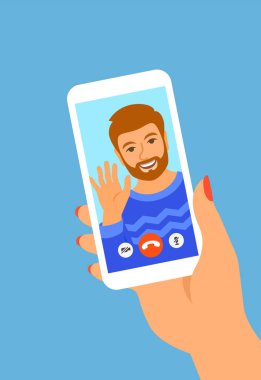 Akıllı telefondan çevrimiçi video görüşmesi. Genç adam, mobil sosyal medya uygulamasındaki arkadaşına merhaba diyor. Çizgi film çizimi. Koronavirüs karantinası sırasında sosyal uzaklık. Sanal sohbet