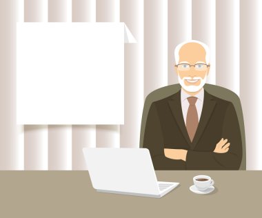 Ofis masasında oturan iş adamı. 