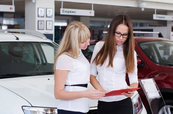 Une jeune femme présente la voiture à une autre femme — Photo