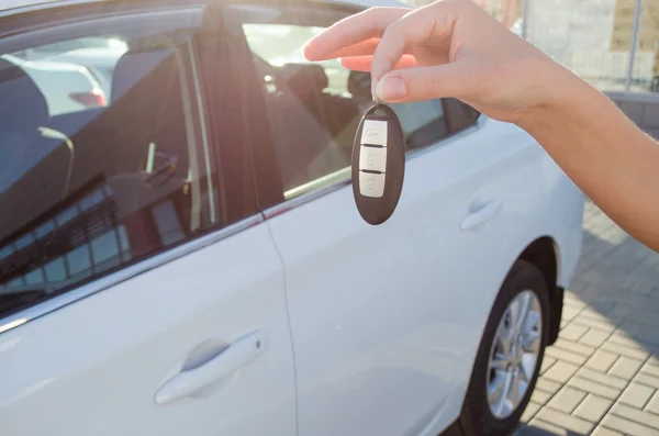 Araba karşı yeni bir araba anahtarlarına gösteri — Stok fotoğraf